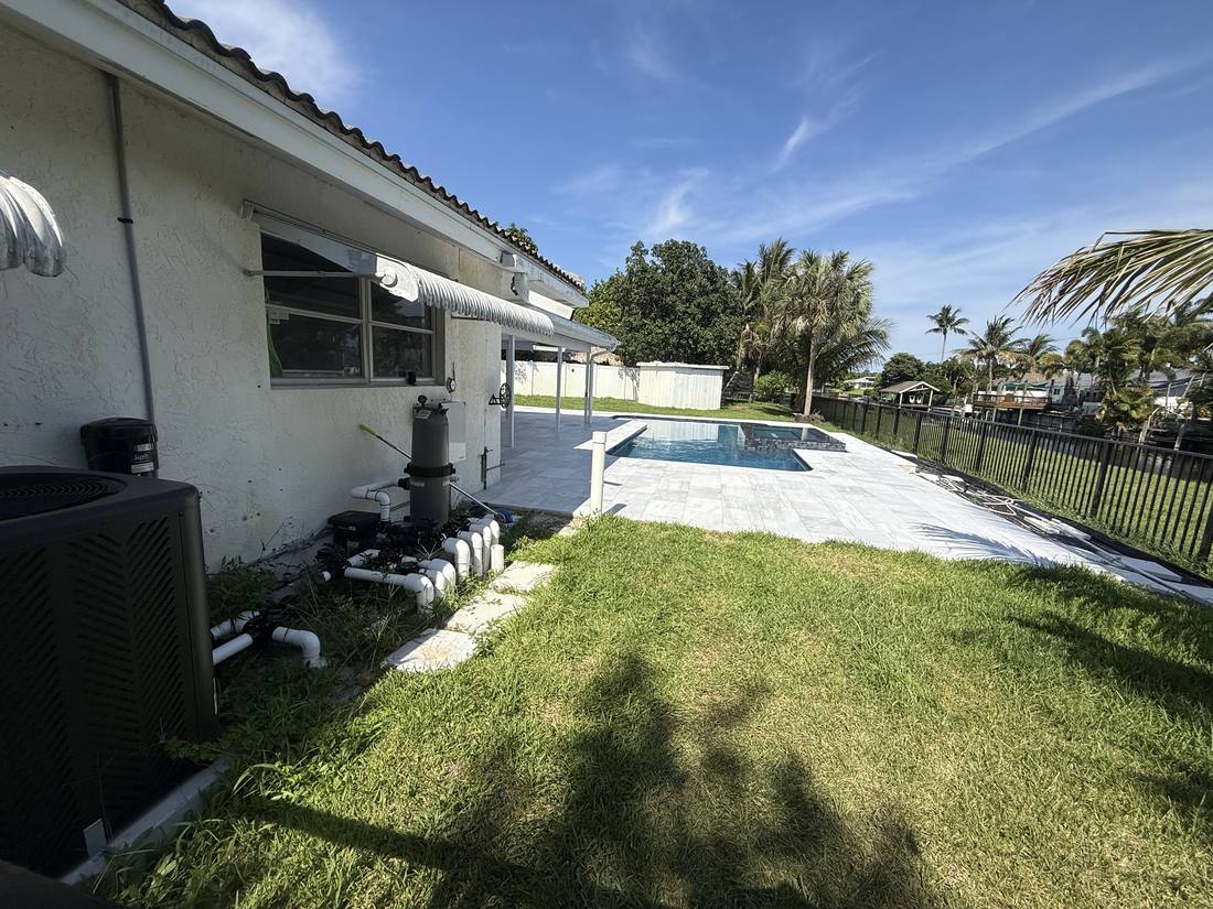 Pool equipment pad at a Boynton Beach home, one of the places a water loss can originate before the plumbing reaches the pool