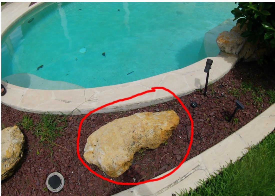 Landscaping bed beside a Greenacres pool with the area of the broken return line marked