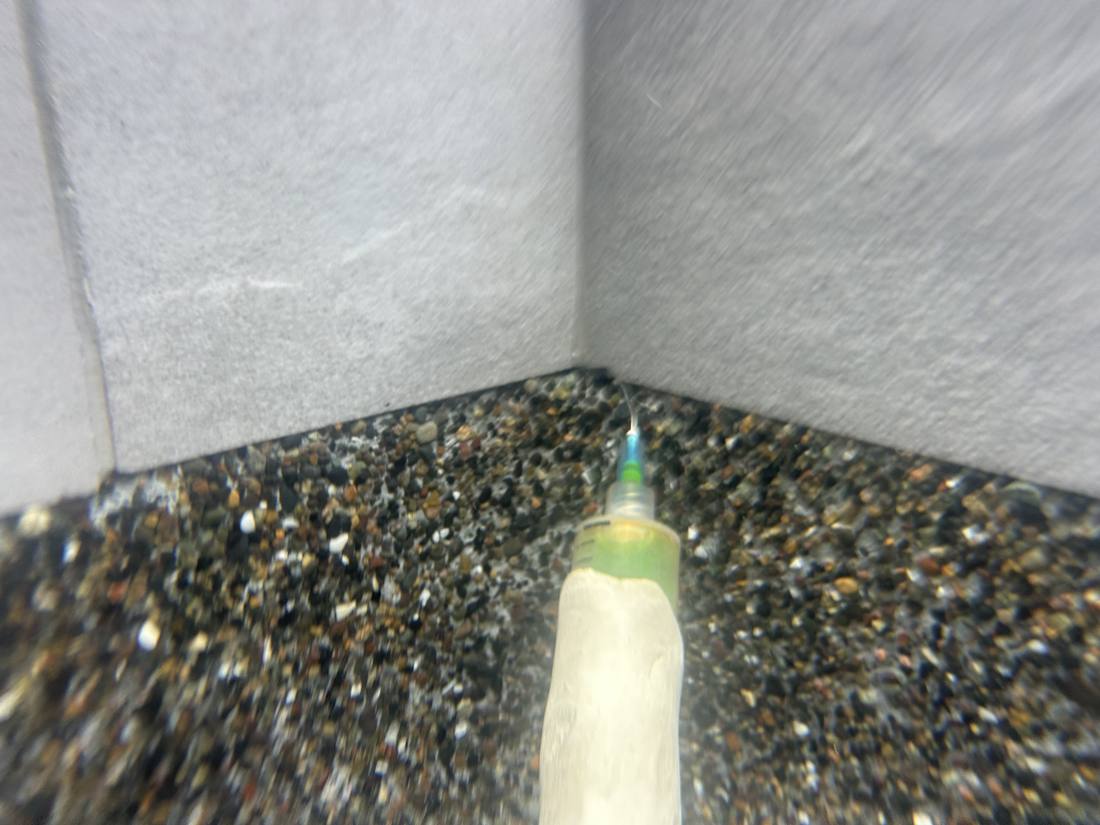 Dye testing at a Jupiter pool, confirming water movement at the joint between the wall and the pebble finish