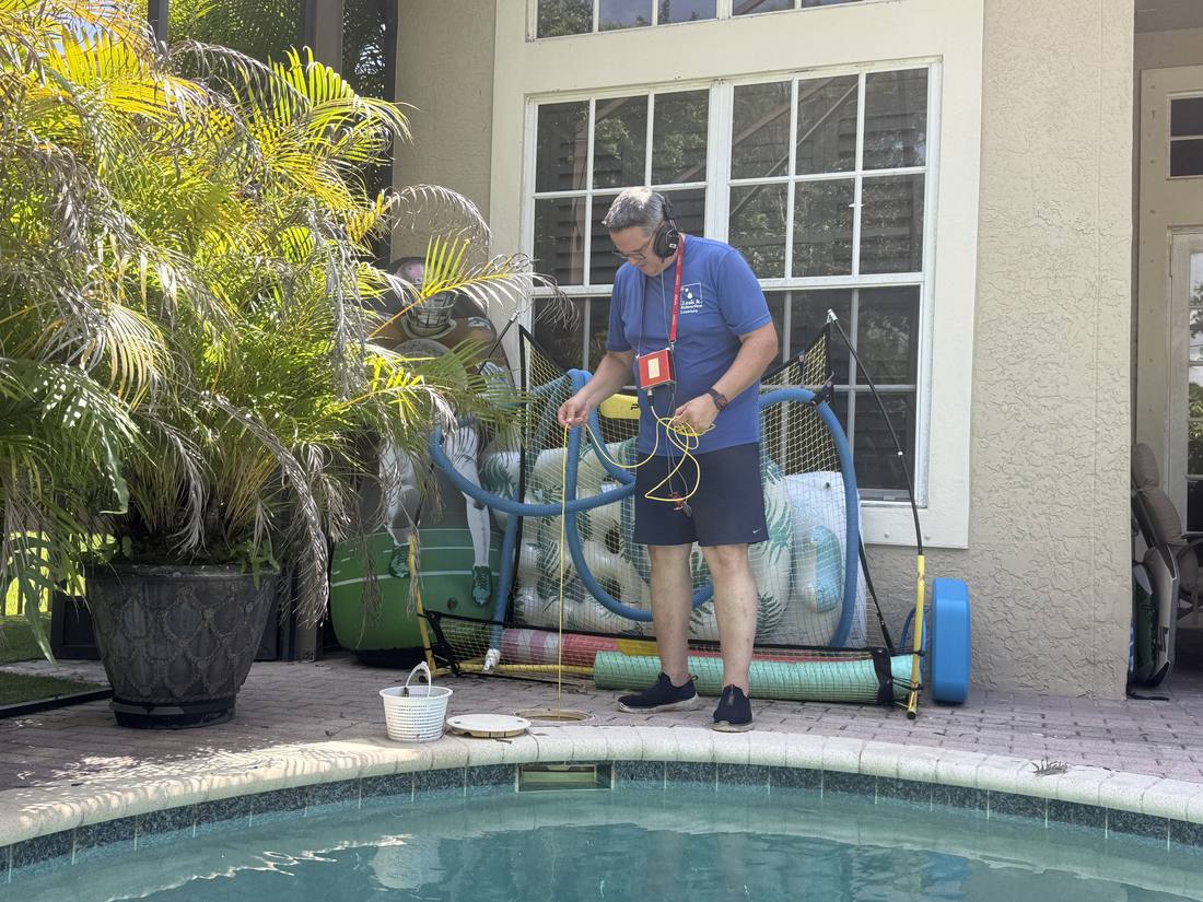 Pressure testing pool plumbing at a Jupiter home, with each line isolated and tested individually