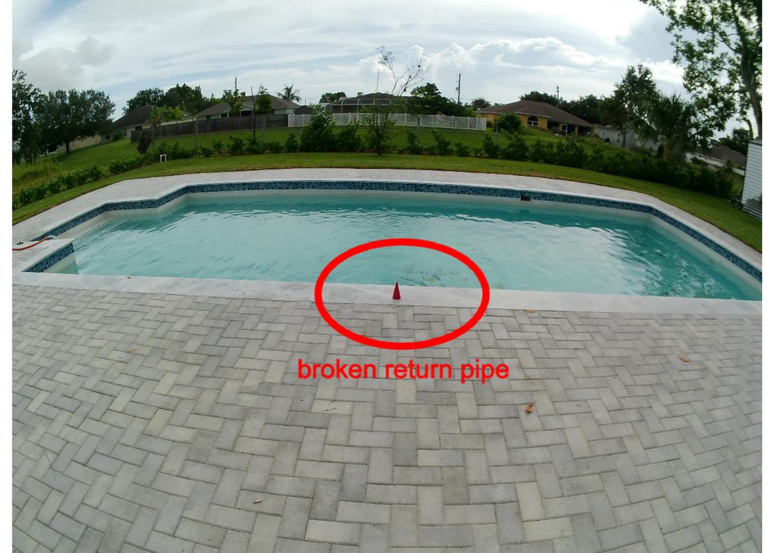 Marked location of a broken pool return pipe found under the patio at a Port St. Lucie home, discovered after a high-pressure line test failed