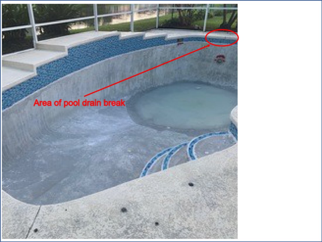 Drained pool shell with the area of the underground drain line break circled