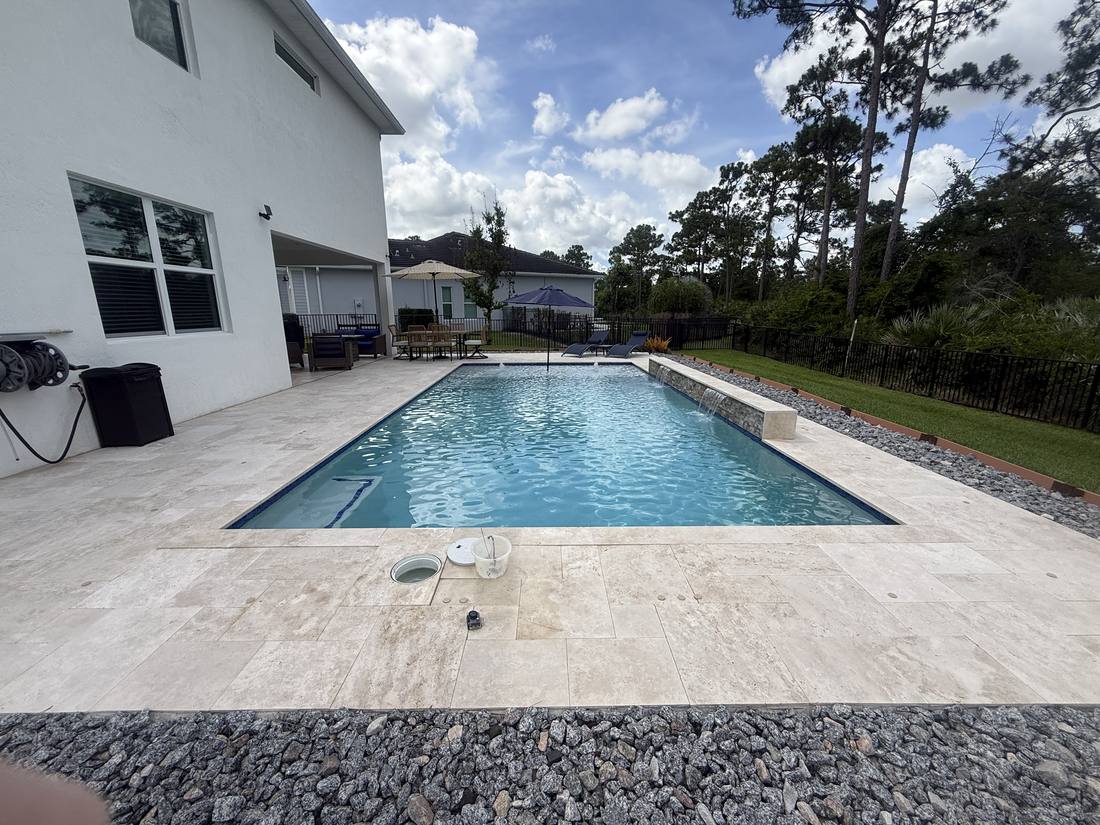 Rectangular pool and travertine deck at a Stuart home during a leak detection visit