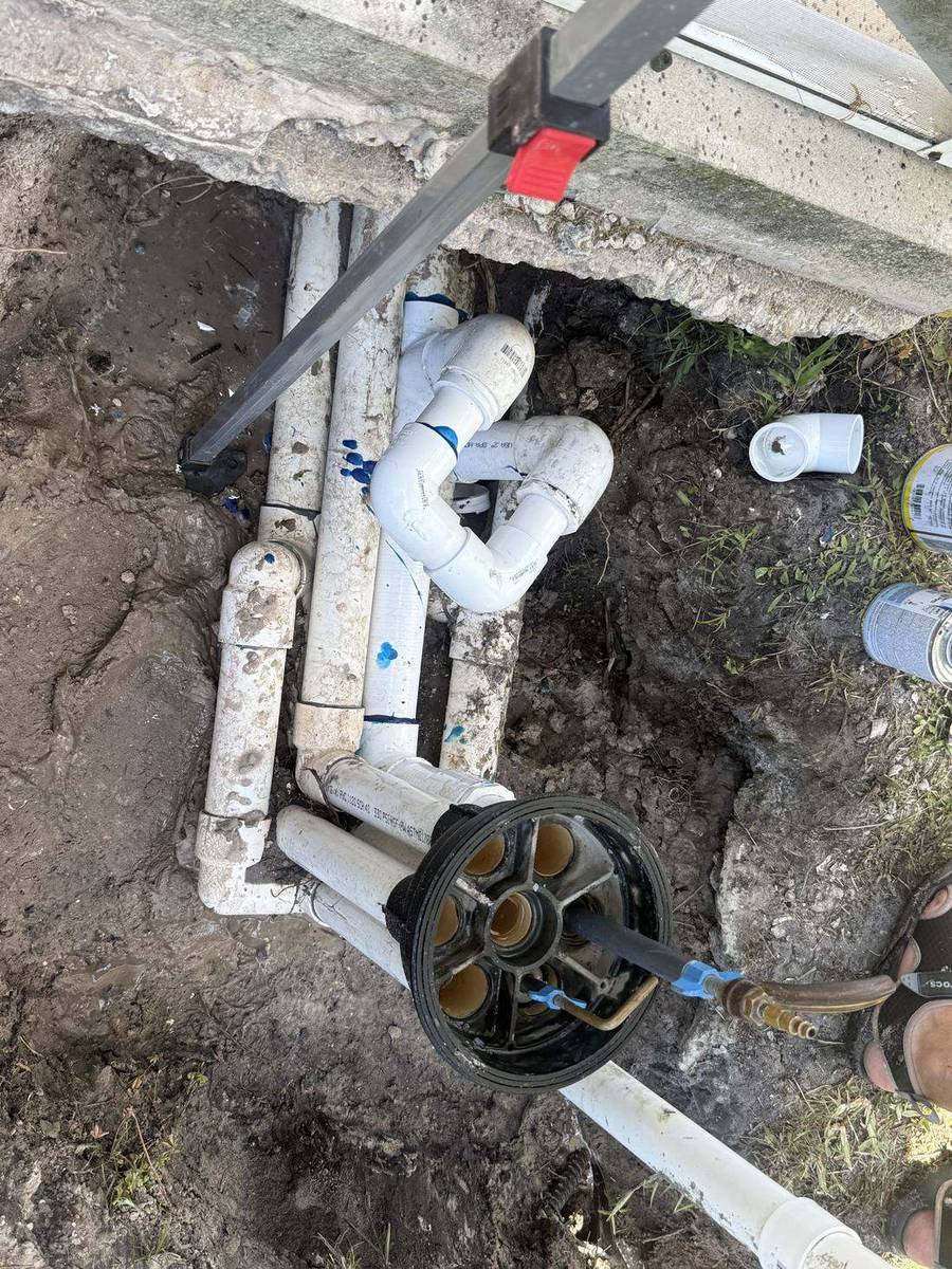 Pool plumbing exposed in an excavated trench at an Acreage property