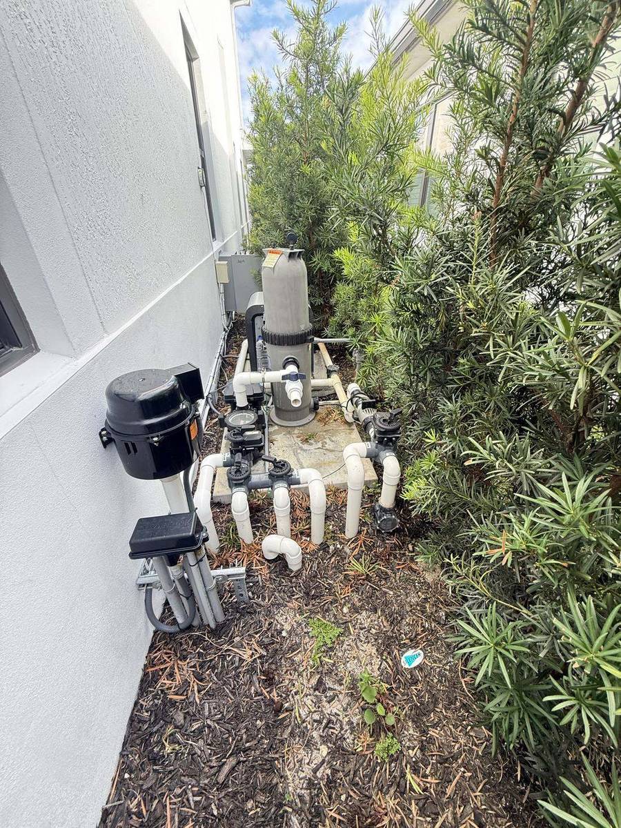 Pool equipment pad at a West Palm Beach home, where a water loss can begin before the plumbing ever reaches the pool