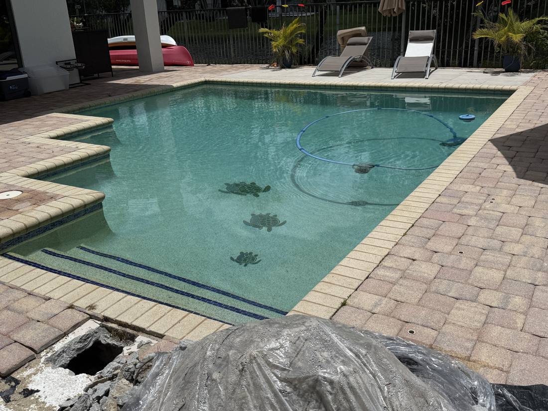 Deck opened beside a Weston pool to reach the plumbing underneath
