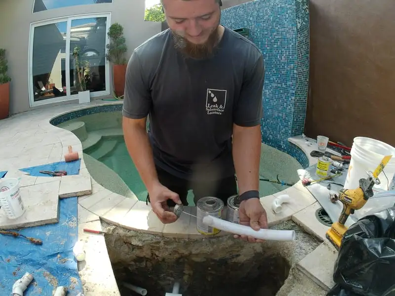 Nathan repairing pool pipes on site